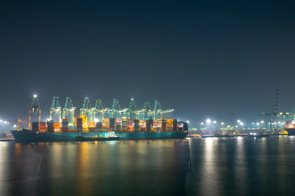 Container terminal at night, with ship-to-shore cranes